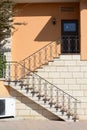 Beautiful stairs with metal railings of orange house outdoors Royalty Free Stock Photo