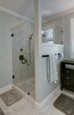 Beautiful stand alone glass shower with luxury marble tile and glass door