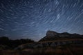 Beautiful star trails time-lapse over the hills. Polar Star at the center of rotation.