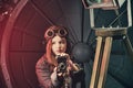 Beautiful steampunk teen girl in goggles with old camera