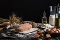Beautiful still life with different kinds of bread, grain, flour on weight, ears of wheat, pitcher of milk and eggs Royalty Free Stock Photo