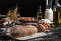 Beautiful still life with different kinds of bread, grain, flour on weight, ears of wheat, pitcher of milk and eggs Royalty Free Stock Photo