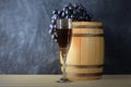 Beautiful still life with glass of red wine against background of oak wine barrel with red wine Royalty Free Stock Photo