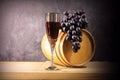 Beautiful still life with glass of red wine against background of oak wine barrel with red wine Royalty Free Stock Photo