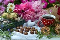 Beautiful still life with peony flowers, vintage cup and cookies on the table. Royalty Free Stock Photo