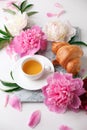 Beautiful still life with tea cup and peonies.Top view, summer french breakfast of bloger, feminine holiday morning concept
