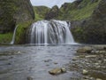 Beautiful Stjornarfoss waterfall in south Iceland near Kirkjubeajarklaustur camp site, with rocks, river stream green cliffs and