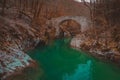 Beautiful stone bridge on Nadige river in enchanted forest Royalty Free Stock Photo