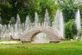 Beautiful stone bridge in traditional chinese park on background of fountains Royalty Free Stock Photo