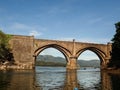 A beautiful stone bridge with two arches at the mouth to the estuary in Galicia (Spain