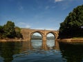 A beautiful stone bridge with two arches at the mouth to the estuary of the Galician coast