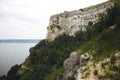 Beautiful stone cliff and big lake. Old stone caves, green hill and river landscape. Bakota lake and Dnister river in Ukraine.