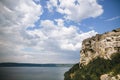 Beautiful stone cliff and big lake. Old stone caves, green hill and river landscape. Bakota lake and Dnister river in Ukraine.