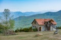 Beautiful stone house in the forest. House with a red roof on the top of the mountain. Beautiful nature and lonely house. Royalty Free Stock Photo