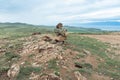 Beautiful stone outlier or rock formation against the background of mountains and Baikal lake. Summer mountain landscape. Royalty Free Stock Photo