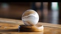 A beautiful stone paperweight sits on a polished wooden desk