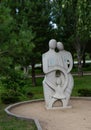 Beautiful stone sculpture of a father mother and child in the historical center of Omsk in summer