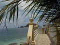 Beautiful stone stairs with the ocean in the background, on the beach of Pulau Kapas island Royalty Free Stock Photo