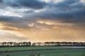Beautiful stormy moody cloudy sky over English countryside lands Royalty Free Stock Photo