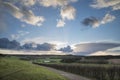 Beautiful stormy moody cloudy sky over English countryside lands Royalty Free Stock Photo