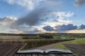 Beautiful stormy moody cloudy sky over English countryside lands Royalty Free Stock Photo