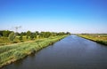 Beautiful straight dutch inland water canal, green rural landscape, riverside cycle trail - North Brabant. near S-Hertogenbosch,