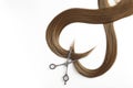 Beautiful strands of brown hair and scissors on white background. Hairdresser service
