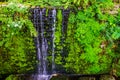 Beautiful streaming waterfall, tropical garden architecture, nature background Royalty Free Stock Photo