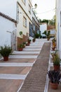 Beautiful street at Alvor. White houses, pots with plants. Portimao, Algarve, Portugal, Royalty Free Stock Photo