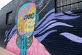 Beautiful street art of colorful figure on black wall, downtown Austin, Texas, 2018