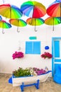 Beautiful street bar (restaurant) decoration with colorful umbrellas, old wooden boat and flowers. Royalty Free Stock Photo