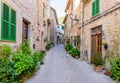 Beautiful street with stone buildings decorated with flowers in Valldemossa old town Royalty Free Stock Photo