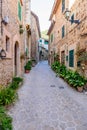 Beautiful street with stone buildings decorated with flowers in Valldemossa old town Royalty Free Stock Photo