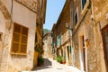 Beautiful street in Valldemossa with traditional flower decoration, famous old mediterranean village of Majorca Royalty Free Stock Photo