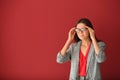 Beautiful stressed businesswoman on color background