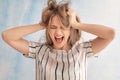 Beautiful stressed woman on color background