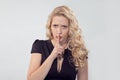 Beautiful strict woman holding finger on lips Royalty Free Stock Photo