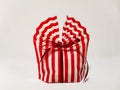 Beautiful striped packing bag tied with a red ribbon with a bow. Gift wrap. Nice gift, surprise. Royalty Free Stock Photo