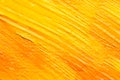 Beautiful strokes of yellow and orange oil paints as background, closeup