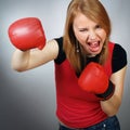 Beautiful strong girl in red gloves for boxing