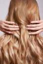 Beautiful strong hair of a woman, strengthening and restoring the hair roots. Beautiful manicure on the hands of a girl