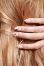 Beautiful strong hair of a woman, strengthening and restoring the hair roots. Beautiful manicure on the hands of a girl