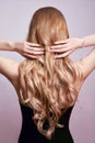 Beautiful strong hair of a woman, strengthening and restoring the hair roots. Beautiful manicure on the hands of a girl