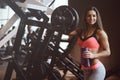 Strong athletic young girl working out in gym Royalty Free Stock Photo