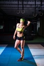 Beautiful, strong, slender, in good physical shape in the gym doing exercises. Dressed in short shorts and tank top green, on the Royalty Free Stock Photo