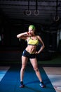 Beautiful, strong, slender, in good physical shape in the gym doing exercises. Dressed in short shorts and tank top green, on the Royalty Free Stock Photo