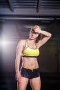 Beautiful, strong, slender, in good physical shape in the gym doing exercises. Dressed in short shorts and tank top green, on the Royalty Free Stock Photo