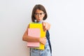 Beautiful student child girl wearing backpack glasses books over isolated white background pointing with finger to the camera and Royalty Free Stock Photo