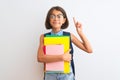 Beautiful student child girl wearing backpack glasses books over isolated white background surprised with an idea or question Royalty Free Stock Photo