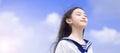 Beautiful student girl enjoying summer breeze , smiling with eyes closed